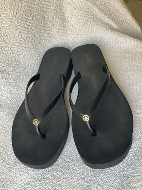 Michael Kors Black Flip Flops with Gold MK Charm